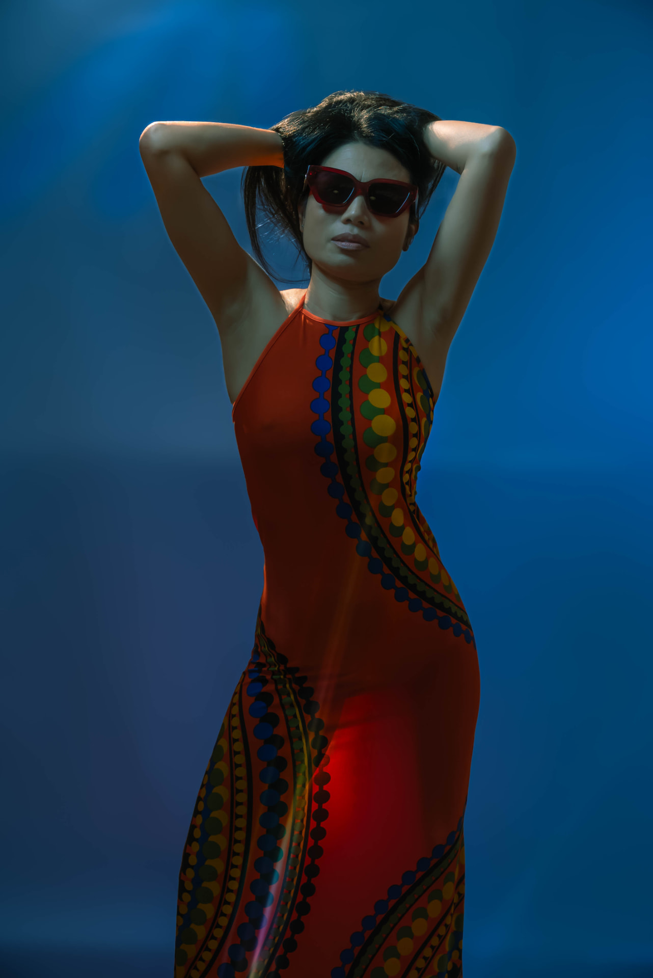 Portrait in blue light against a patterned backdrop