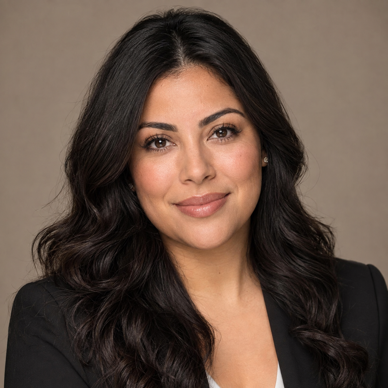 Directed professional headshot of a woman against a warm taupe ground